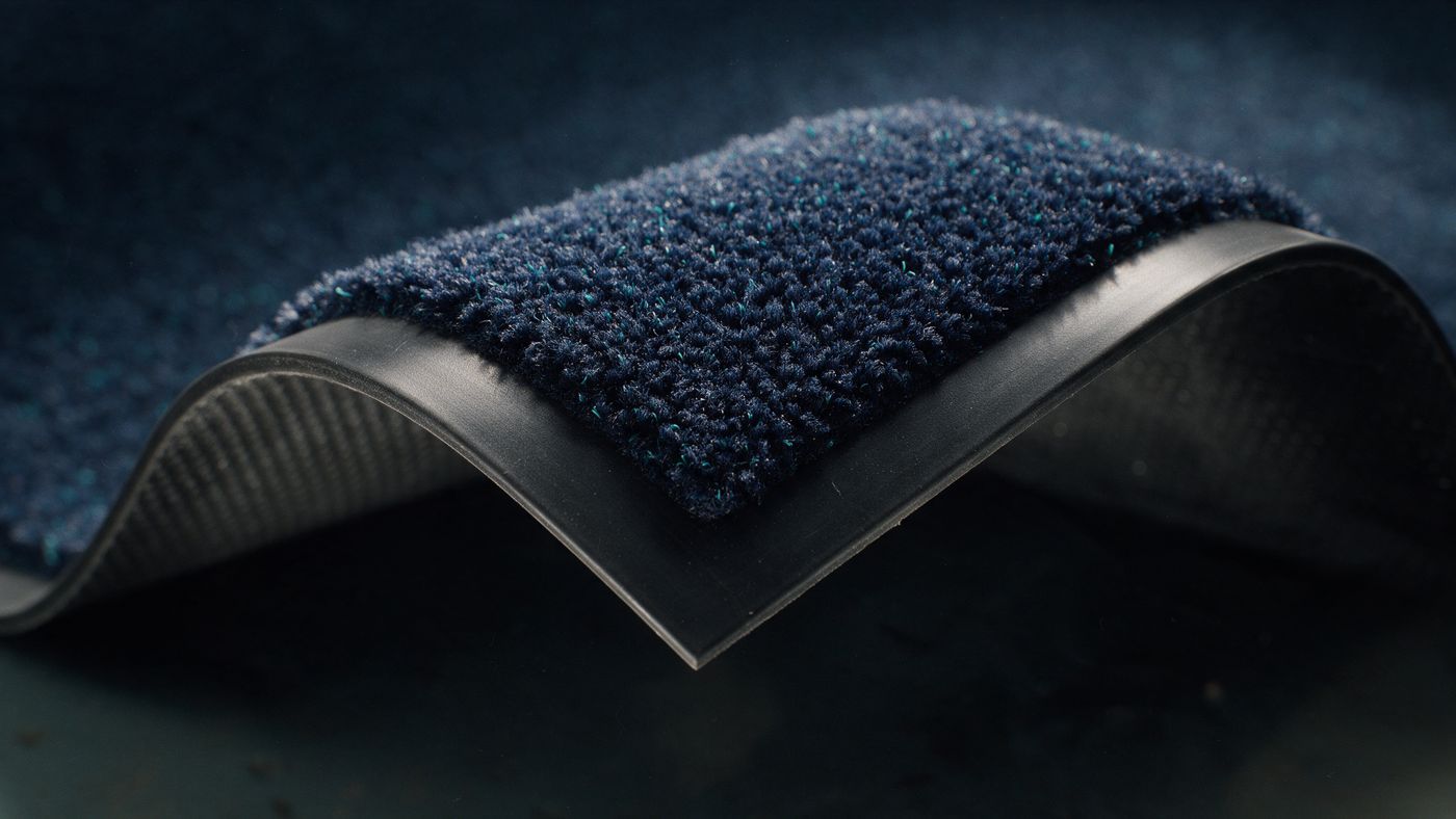 Close-up of dense mat pile meeting a rubber border